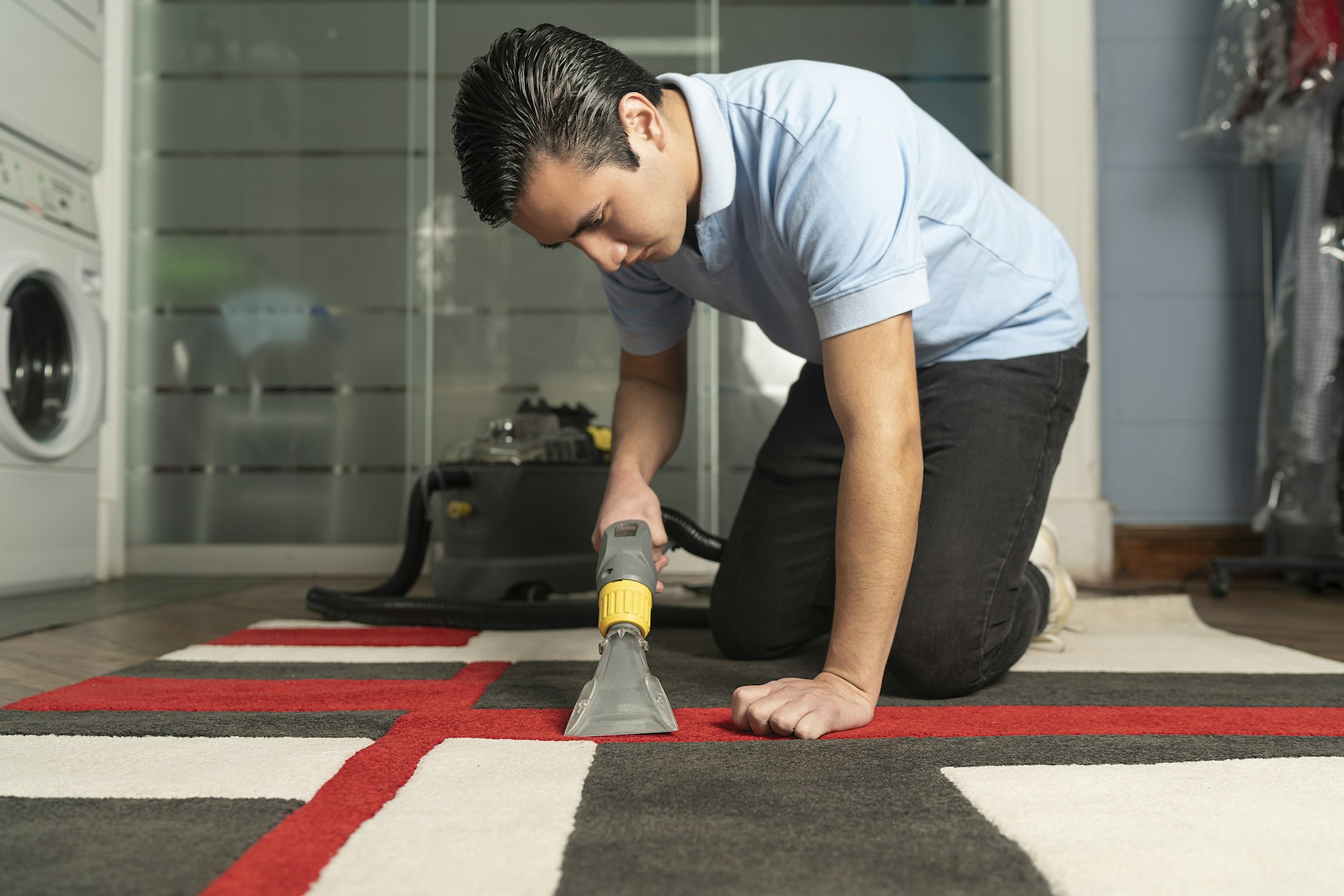 Laundry worker cleaning carpet with special equipment